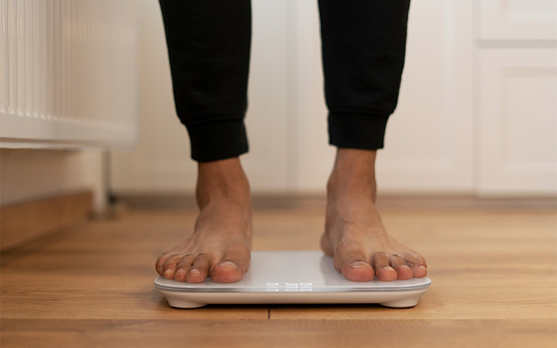 Person standing on digital bathroom scale.